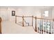 This hallway features wood and white railings, white walls, carpet and several doors at 548 Fairwoods Dr, Huntersville, NC 28078
