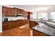 Gourmet kitchen boasts dark countertops, custom cabinetry, and stainless steel appliances at 548 Fairwoods Dr, Huntersville, NC 28078