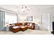This living room features a brown leather sectional, two side tables, and a white ceiling fan at 548 Fairwoods Dr, Huntersville, NC 28078