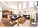 Spacious open-plan living room with hardwood floors and fireplace adjacent to the modern kitchen at 548 Fairwoods Dr, Huntersville, NC 28078