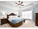 Relaxing bedroom with tray ceilings, a ceiling fan, and a large window with natural light at 548 Fairwoods Dr, Huntersville, NC 28078