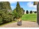 Outdoor patio with a modern fire pit and manicured bushes at 548 Fairwoods Dr, Huntersville, NC 28078