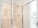 Tiled shower with bench and glass doors, featuring neutral colors and great lighting at 548 Fairwoods Dr, Huntersville, NC 28078
