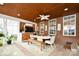 Elegant sunroom with brick walls, dining, and living area at 548 Fairwoods Dr, Huntersville, NC 28078