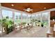 Bright sunroom filled with plants and comfortable seating at 548 Fairwoods Dr, Huntersville, NC 28078