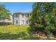 Backyard view of house with light siding and large trees at 5611 Hammermill Dr, Harrisburg, NC 28075