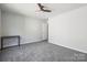Neutral bedroom features plush carpet, ceiling fan, and natural light at 5611 Hammermill Dr, Harrisburg, NC 28075