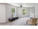 Bedroom with ceiling fan, large windows and light gray walls with neutral carpet at 5611 Hammermill Dr, Harrisburg, NC 28075