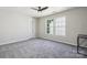 Bedroom features neutral walls, ceiling fan, and lots of natural light at 5611 Hammermill Dr, Harrisburg, NC 28075