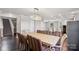 Large dining room with hardwood floors and modern chandelier open to kitchen at 5611 Hammermill Dr, Harrisburg, NC 28075