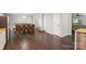 Bright dining area features hardwood floors, modern light fixture, and seating for eight at 5611 Hammermill Dr, Harrisburg, NC 28075