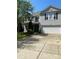 Two-story home with vinyl siding, a two-car garage, manicured lawn and mature shade tree at 5611 Hammermill Dr, Harrisburg, NC 28075