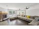 Bright living area with hardwood floors, a stone fireplace, and a large, comfortable sectional sofa at 5611 Hammermill Dr, Harrisburg, NC 28075