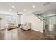 Spacious living room features hardwood floors, neutral color palette and plenty of natural light at 5611 Hammermill Dr, Harrisburg, NC 28075