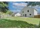Large fenced backyard with a lush lawn, mature trees, patio and views of the rear of the home at 599 Annalinde Ln, Rock Hill, SC 29732