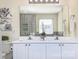 Bathroom with double sink vanity, floral art, large mirror and granite counter tops at 599 Annalinde Ln, Rock Hill, SC 29732