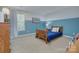 A bedroom painted with blue and white features a wood frame bed, and a view of a large window at 599 Annalinde Ln, Rock Hill, SC 29732