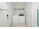 Efficient laundry room with washer, dryer, and shelving for storage at 599 Annalinde Ln, Rock Hill, SC 29732