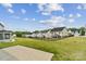 A lush backyard on a sunny day is lined with black fencing for privacy at 6114 Alsace Ln, Indian Land, SC 29707