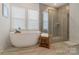Bright bathroom featuring a freestanding tub, large window, and walk-in shower at 6114 Alsace Ln, Indian Land, SC 29707