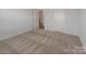 Bright bedroom features neutral carpeting, white walls, and ample natural light from the windows at 6114 Alsace Ln, Indian Land, SC 29707