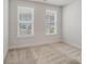 Neutral bedroom with plush carpet, two bright windows, and white trim at 6114 Alsace Ln, Indian Land, SC 29707