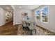 Bright dining room featuring a glass table with upholstered chairs, a modern rug, and natural light from a large window at 6114 Alsace Ln, Indian Land, SC 29707