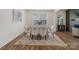 Bright dining room featuring a glass table with upholstered chairs, a modern rug, and natural light from a large window at 6114 Alsace Ln, Indian Land, SC 29707