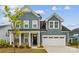 Charming two-story home with blue siding, a two-car garage, and a welcoming front porch in a well-kept neighborhood at 6114 Alsace Ln, Indian Land, SC 29707