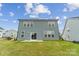 Two-story home's exterior features a well-maintained lawn and access to a patio through sliding glass doors at 6114 Alsace Ln, Indian Land, SC 29707