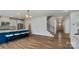 Open-concept kitchen boasts a large island with seating, stainless steel appliances, and wood-look flooring at 6114 Alsace Ln, Indian Land, SC 29707