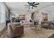 Open-concept living room with a view into the kitchen and dining area, featuring modern furnishings and hardwood floors at 6114 Alsace Ln, Indian Land, SC 29707