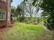 A lush green backyard featuring a view of an arched arbor and plenty of shade trees at 6316 Glengarrie Ln, Huntersville, NC 28078