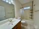 Well-lit bathroom with a sink vanity, toilet, and shower-tub combo at 6316 Glengarrie Ln, Huntersville, NC 28078