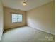 Bedroom with neutral carpet, a window with blinds, and painted walls at 6316 Glengarrie Ln, Huntersville, NC 28078