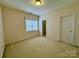 Bedroom with beige carpet, a window with blinds and neutral paint at 6316 Glengarrie Ln, Huntersville, NC 28078