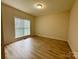 A clean, empty bedroom with hardwood floors and a single window at 6316 Glengarrie Ln, Huntersville, NC 28078