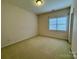 Beige bedroom with carpeted floor and a view from the window at 6316 Glengarrie Ln, Huntersville, NC 28078