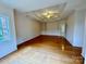 A well-lit bedroom features a tray ceiling, crown molding, hardwood floors, and a large window at 6316 Glengarrie Ln, Huntersville, NC 28078