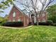 Beautiful two-story brick home featuring stately columns and a well-manicured front lawn at 6316 Glengarrie Ln, Huntersville, NC 28078