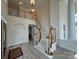 Bright open foyer with staircase, arched walls, detailed trim and luxury vinyl flooring at 6316 Glengarrie Ln, Huntersville, NC 28078