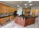 Large kitchen with granite countertops, wood cabinets, and updated stainless steel appliances at 6316 Glengarrie Ln, Huntersville, NC 28078
