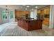 Expansive kitchen with wood cabinets, granite countertops, and a large central island at 6316 Glengarrie Ln, Huntersville, NC 28078