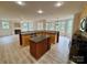 Open kitchen with granite countertops, wooden cabinetry, and a central island at 6316 Glengarrie Ln, Huntersville, NC 28078