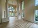 Bright living room boasts tall windows, hardwood floors, and elegant architectural columns at 6316 Glengarrie Ln, Huntersville, NC 28078