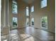 Spacious living room with soaring ceilings, large windows, and hardwood flooring at 6316 Glengarrie Ln, Huntersville, NC 28078