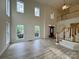 Open-concept living room with hardwood floors and a staircase leading to the second level at 6316 Glengarrie Ln, Huntersville, NC 28078