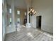 Grand living room with hardwood floors, tall ceilings and an elegant chandelier at 6316 Glengarrie Ln, Huntersville, NC 28078