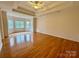 Spacious main bedroom with tray ceilings, hardwood floors, and bay windows at 6316 Glengarrie Ln, Huntersville, NC 28078