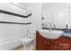 Well-lit bathroom with a shower-tub combination, dark wood vanity, and a stone countertop at 656 Garden District Dr, Charlotte, NC 28202